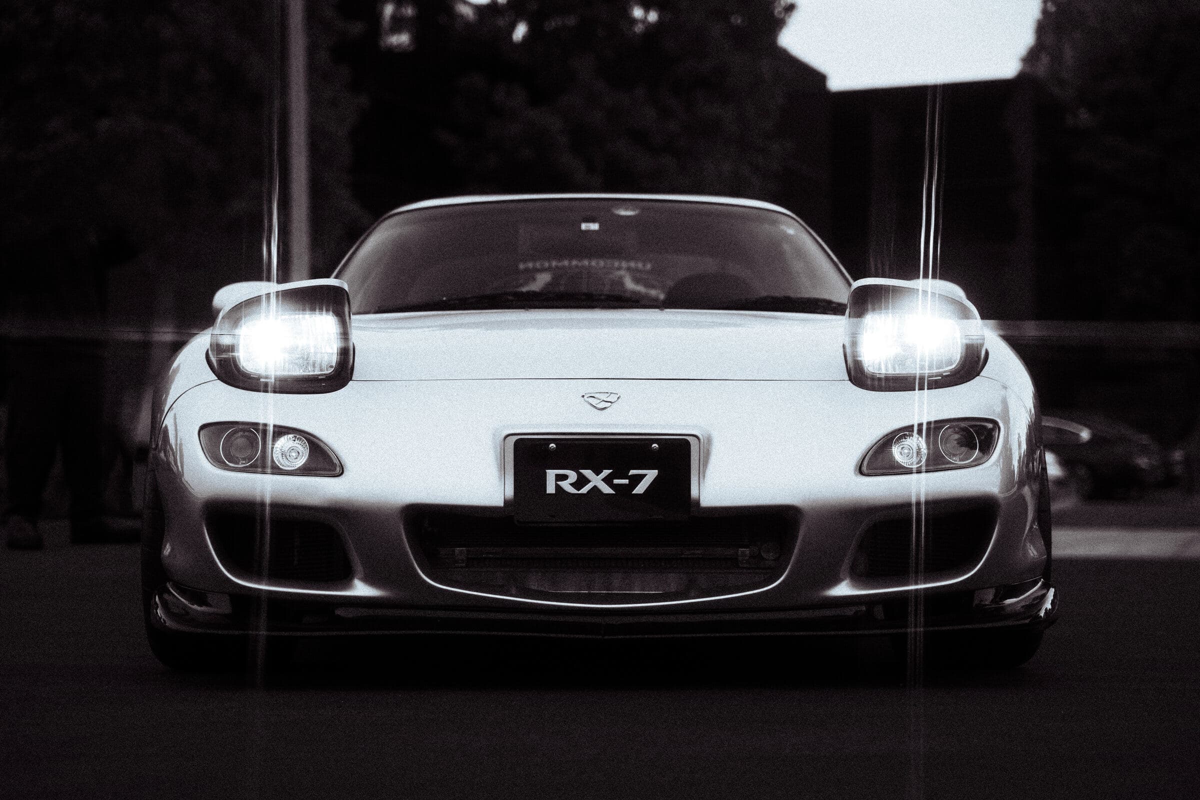 RX-7 front end at night, headlights lit