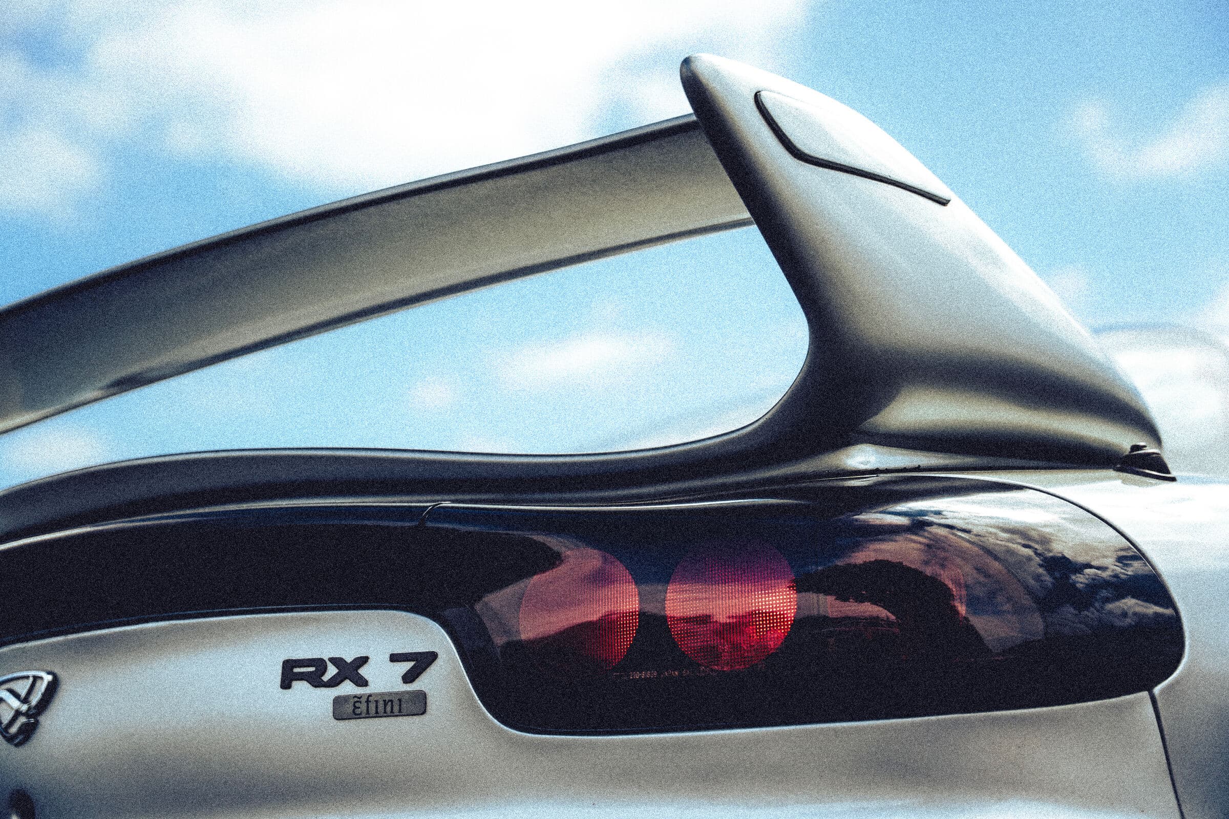 RX-7 rear wing detail against the sky